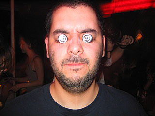 Crazy Q attaches Bit Shifter pins to his eyelids in a ritualistic show of devotion, 2004 11 18, image 43 of 54.